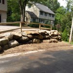 New Retaining Wall, Wooden Fence, and Installation of Stone for Drainage
